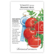 Seed packet for Mountain Merit Bush Tomato illustrating clusters of round red tomatoes with green vines in a wire cage, alongside a blue ribbon graphic and printed text noting it's frost sensitive, 75 days from transplanting, determinate, and disease-resistant.