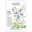 Seed packet for Butterfly Blend Delphinium illustrated with tall spires of blue, lavender, pink, and white flowers among ferny green foliage, a butterfly perched among the blooms, with printed text noting it's a full sun to part shade perennial heirloom blooming late spring to summer, 12–16 inches tall.
