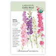 Seed packet for Galilee Blend Larkspur showing illustrated tall flower spikes in pink, purple, cream, and magenta with feathery green foliage, plus text noting it's an organic annual for full sun, blooming spring to summer, growing 3 to 4 feet tall.