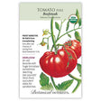 Seed packet for Beefsteak Pole Tomato featuring a detailed illustration of large, ribbed red tomatoes on a leafy vine, with a USDA Organic seal and printed text noting it's frost sensitive, indeterminate, heirloom, 96 days from transplanting, and prized for huge slicing fruit up to two pounds.