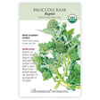 Seed packet for organic heirloom Broccoli Raab Rapini featuring a detailed illustration of jagged green leaves with small broccoli-like flowering shoots, plus text noting it's frost tolerant, ready in 45 days, and known for its spicy flavor and edible leaves.