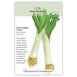 Seed packet for King Richard organic leek featuring a botanical illustration of two leeks with long white stalks, tangled roots, and broad green leaves, alongside text noting frost tolerance, 75-day maturity, spring or summer sowing, and a description of its mild onion flavor.