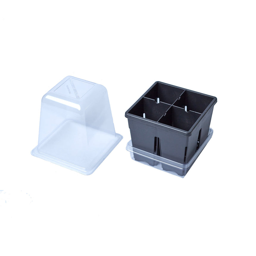 Black four-cell plastic seed starter tray with a clear drip tray underneath, shown beside its separate clear plastic humidity dome, against a white background.