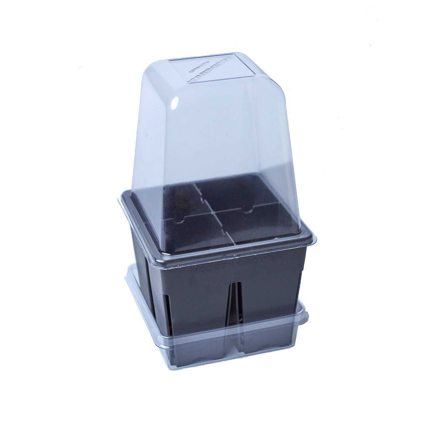 Small black four-cell seedling tray with a matching drip tray beneath it and a clear plastic humidity dome fitted on top, shown against a plain white background.