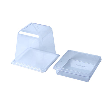 Clear plastic humidity dome with a vented top sits beside its matching square bottom tray, both shown empty against a white background.