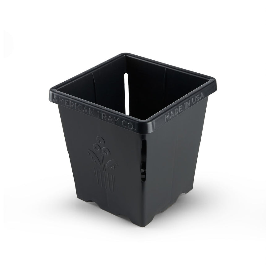 Black square plastic nursery pot with ribbed sides and drainage slots, embossed with a flower motif and "American Tray Co., Made in USA" text along the rim, shown on a plain white background.