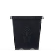 Black square plastic plant pot with tapered sides, embossed with an "American Tray Co." wordmark and a stylized three-flower motif on the front panel, shown against a plain white background.
