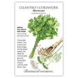 Botanical Interests Moroccan Cilantro/Coriander seed packet illustrating a tied bundle of leafy cilantro, a wooden scoop of round tan and brown seeds, a white flower cluster, and feathery seed-stalk foliage, with printed text noting it's an annual for full sun to part shade, sown in spring and late summer, prized for extra-large seeds ideal for homemade ground coriander.