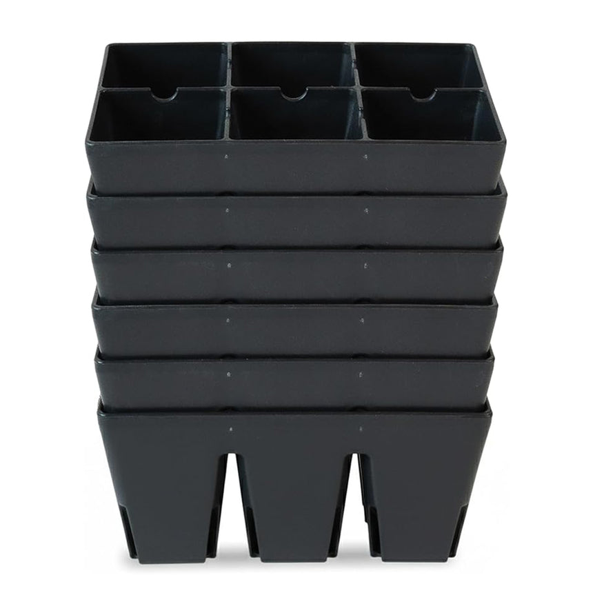 Black plastic six-cell seed starting trays, stacked several deep, each divided into six square compartments for individual seedlings, shown against a plain white background.