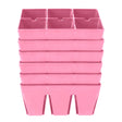 Six pink plastic seed-starting trays, each divided into six deep square cells, stacked in a tower against a plain white background.