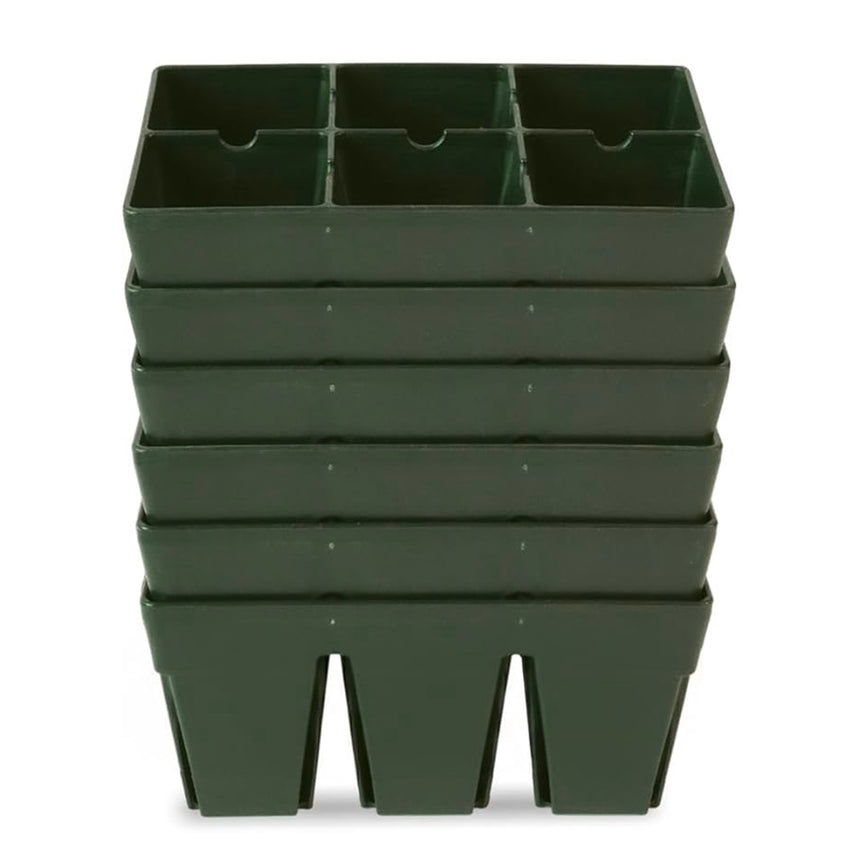 Six dark green plastic seed-starting trays, each divided into six planting cells, stacked one atop another against a plain white background.