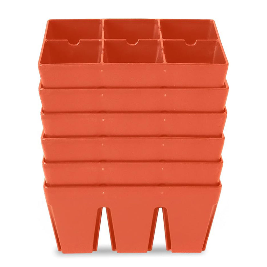 Stack of terracotta-coloured plastic seed starting trays, each divided into six square cells, shown nested together against a plain white background.