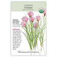 Seed packet for Common Chives (Allium schoenoprasum) featuring an illustration of pink pom-pom flower clusters atop slender green stalks, with USDA Organic seal and text noting it's a perennial, heirloom variety grown in full sun to part shade with edible flowers and onion-flavored foliage.