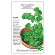 Seed packet for Botanical Interests Baby Greens Superfoods blend, illustrated with a wooden bowl of assorted brassica leaves in varied shapes and shades of green, with text noting 23–35 days to maturity, indoor sowing year-round, and a fritatta recipe inside.