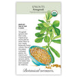 Seed packet for organic Fenugreek Sprouts illustrated with a leafy green fenugreek plant and a blue bowl of tangled white and gold sprouts with scattered seeds, with text noting sprouts grow in 2–4 days and describing their nutty, maple-like flavor.