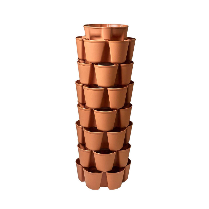 Terracotta-coloured GreenStalk vertical planter tower with seven stacked tiers, each ring featuring multiple outward-facing planting pockets around a central column, photographed against a plain white background.