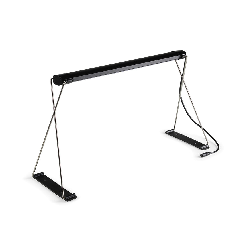 Small Epic seed-starting grow light with a black horizontal LED bar mounted on an X-shaped chrome wire stand with flat black feet and a power cable trailing from one leg, shown on a plain white background.