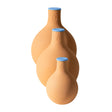 Three terracotta Garden Oya watering pots in graduated bulb shapes with rounded bases and narrow necks, each sealed with a blue lid stamped with a water-drop symbol, arranged large to small.