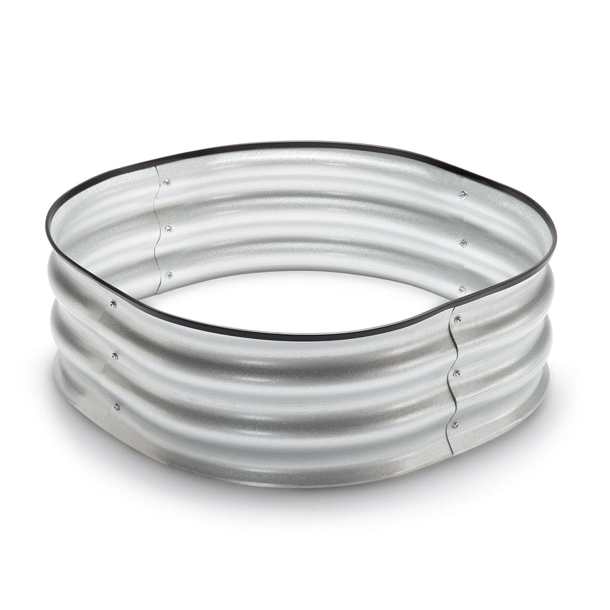Round galvanised metal tree surround, 8 inches tall, made from corrugated steel panels joined with visible screws and a black rimmed edge, empty and unassembled on a white background.