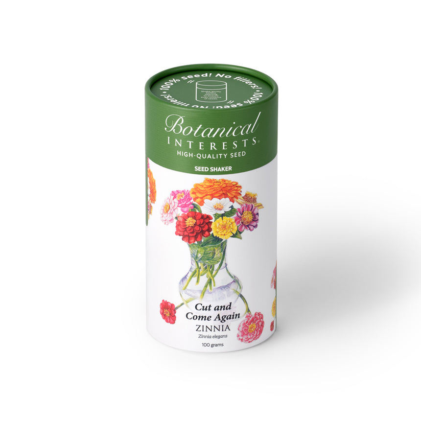 Botanical Interests Cut and Come Again Zinnia 100-gram seed shaker tube on a plain white background, featuring a green lid and floral illustration of colorful zinnia blooms in a vase.