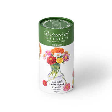 Botanical Interests Cut and Come Again Zinnia 100-gram seed shaker tube on a plain white background, featuring a green lid and floral illustration of colorful zinnia blooms in a vase.