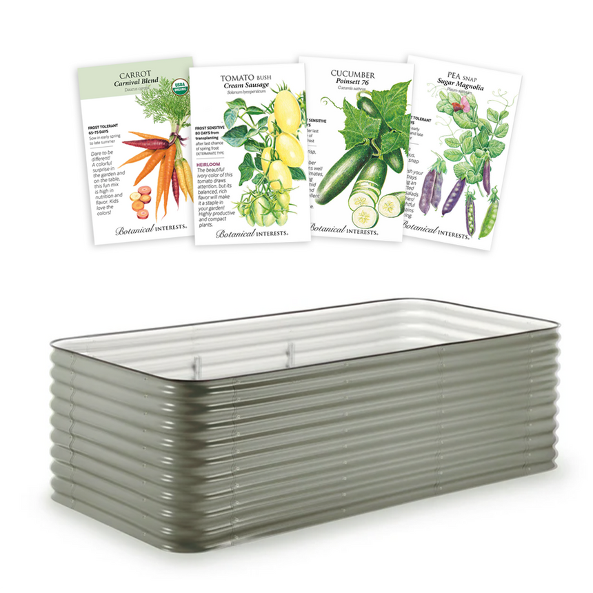 Rectangular corrugated metal raised garden bed in a muted green finish, shown with four illustrated Botanical Interests seed packets above it labelled Carrot Carnival Blend, Tomato Bush Cream Sausage, Cucumber Poinsett 76, and Pea Snap Sugar Magnolia.