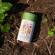 Botanical Interests Midwest Prairie Splendor Flower Mix Seed Shaker canister on soil with plants around